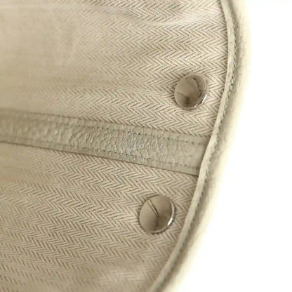 Hermes Garden Party Neo 23 interior pocket with two snap buttons and light beige woven lining