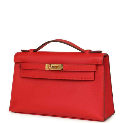 Red leather pochette front view with gold-tone clasp and top handle