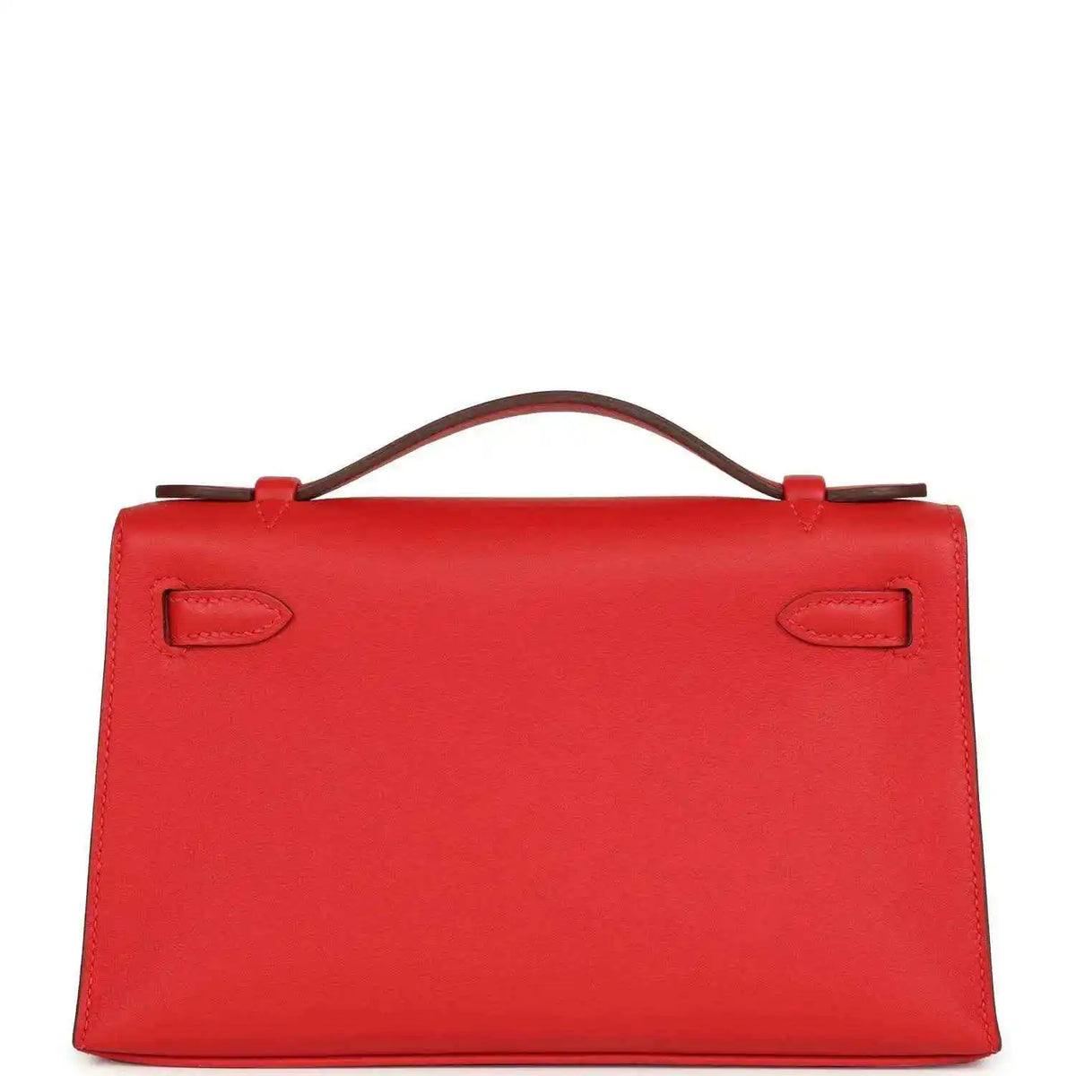 Red leather pochette back view with two embossed strap tabs and top handle