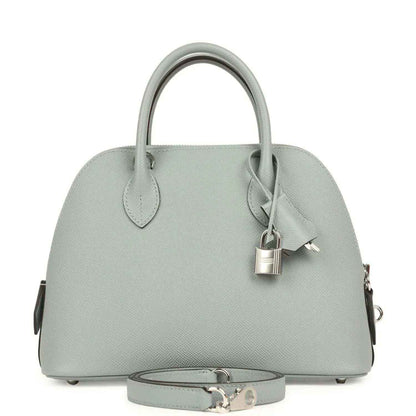 Light gray leather handbag with top handles, structured dome shape, silver-tone clasp