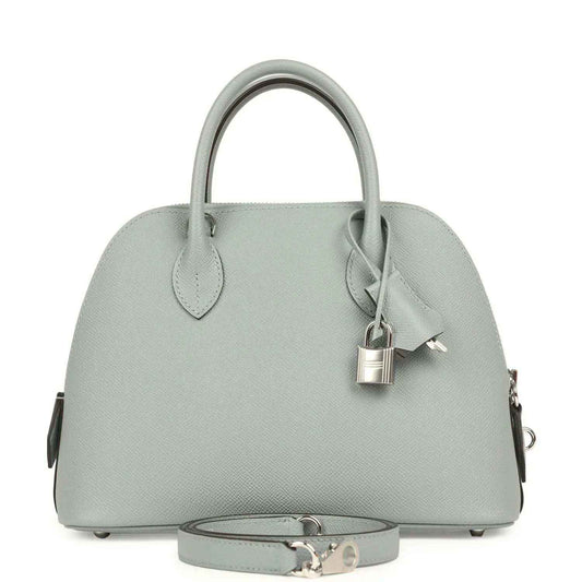 Light gray leather handbag with top handles, structured dome shape, silver-tone clasp