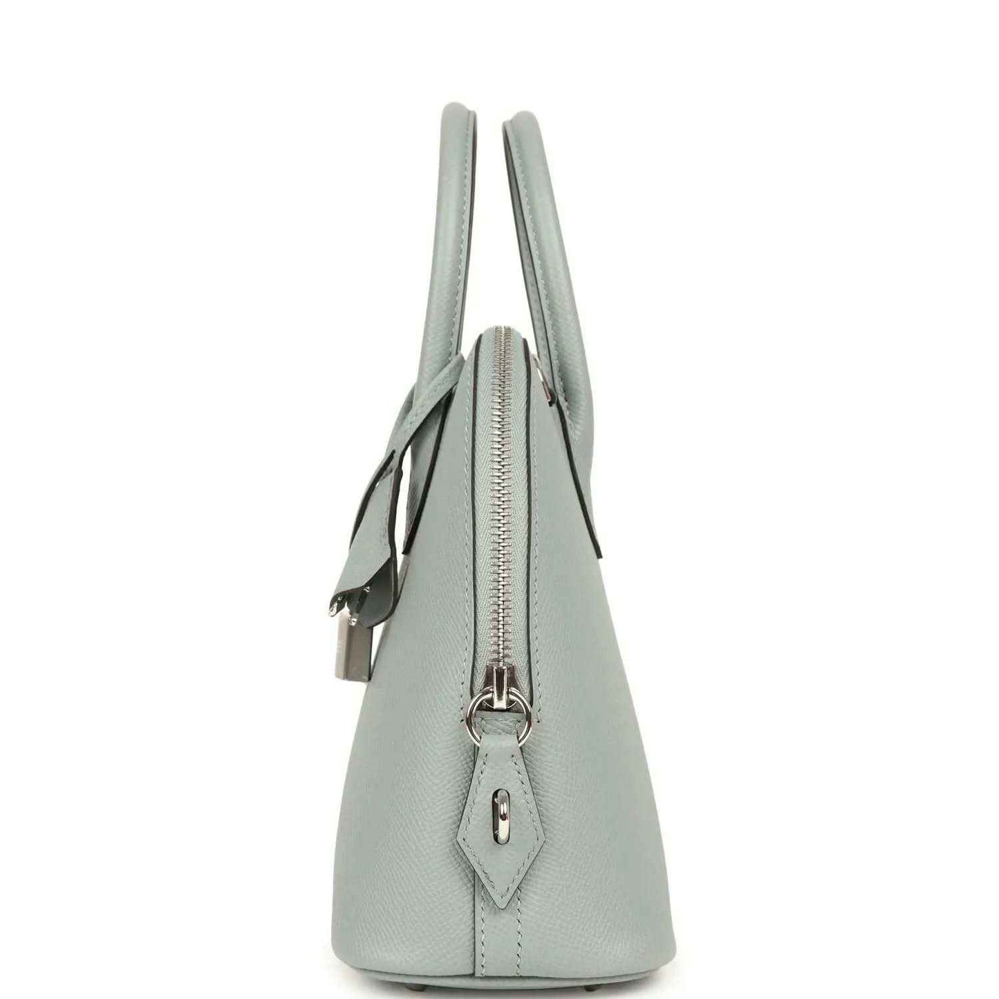 Light gray leather handbag side profile with zipper closure and hanging charm tab