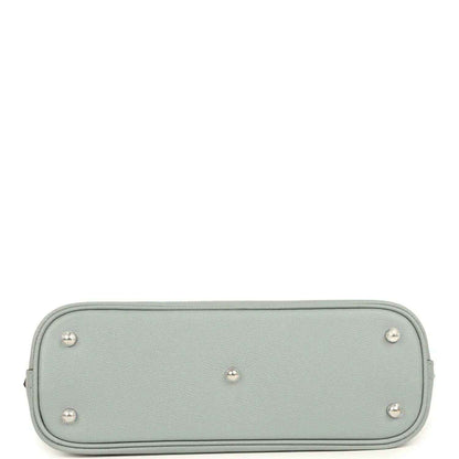Light gray leather handbag base with four metal feet studs and rounded corners