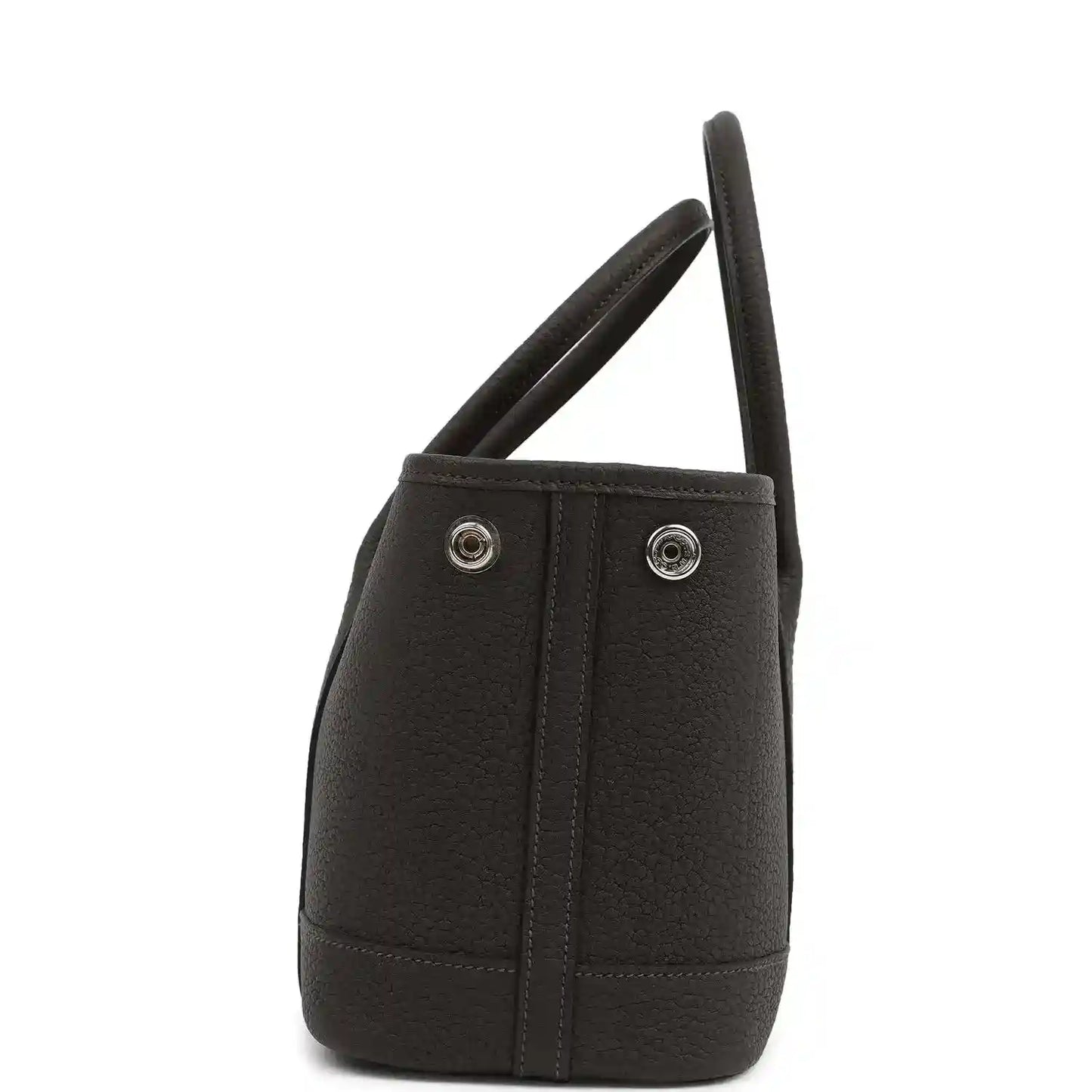 Leather tote bag side view with dual handles and two metal snap buttons