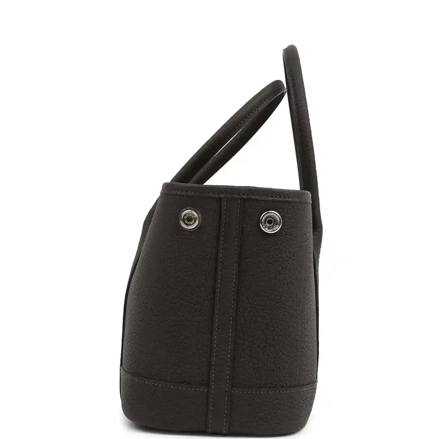 Leather tote bag side view with dual handles and two metal snap buttons