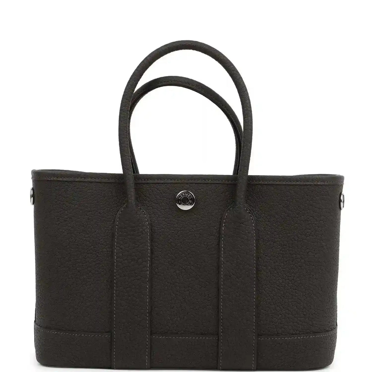 Leather tote bag with top handles and three front vertical panels, center snap