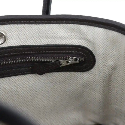 Leather zip pocket detail with silver-tone zipper pull and H logo on lining