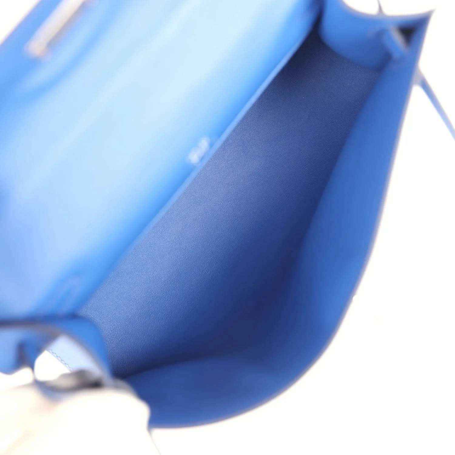 Hermes Kelly Pochette royal blue leather interior with visible stitching and strap