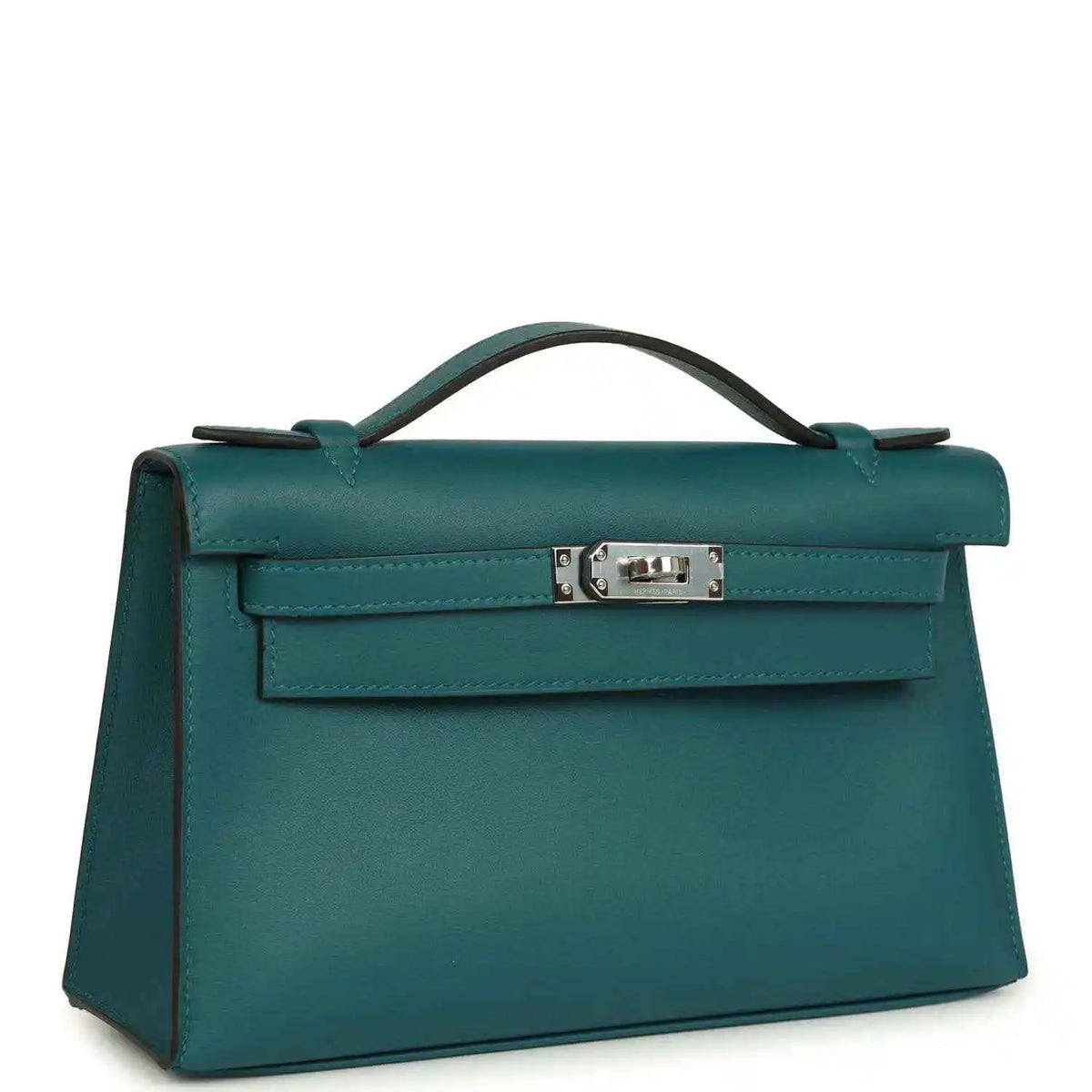 Teal green leather top-handle bag with front flap and silver-toned clasp, angled view.