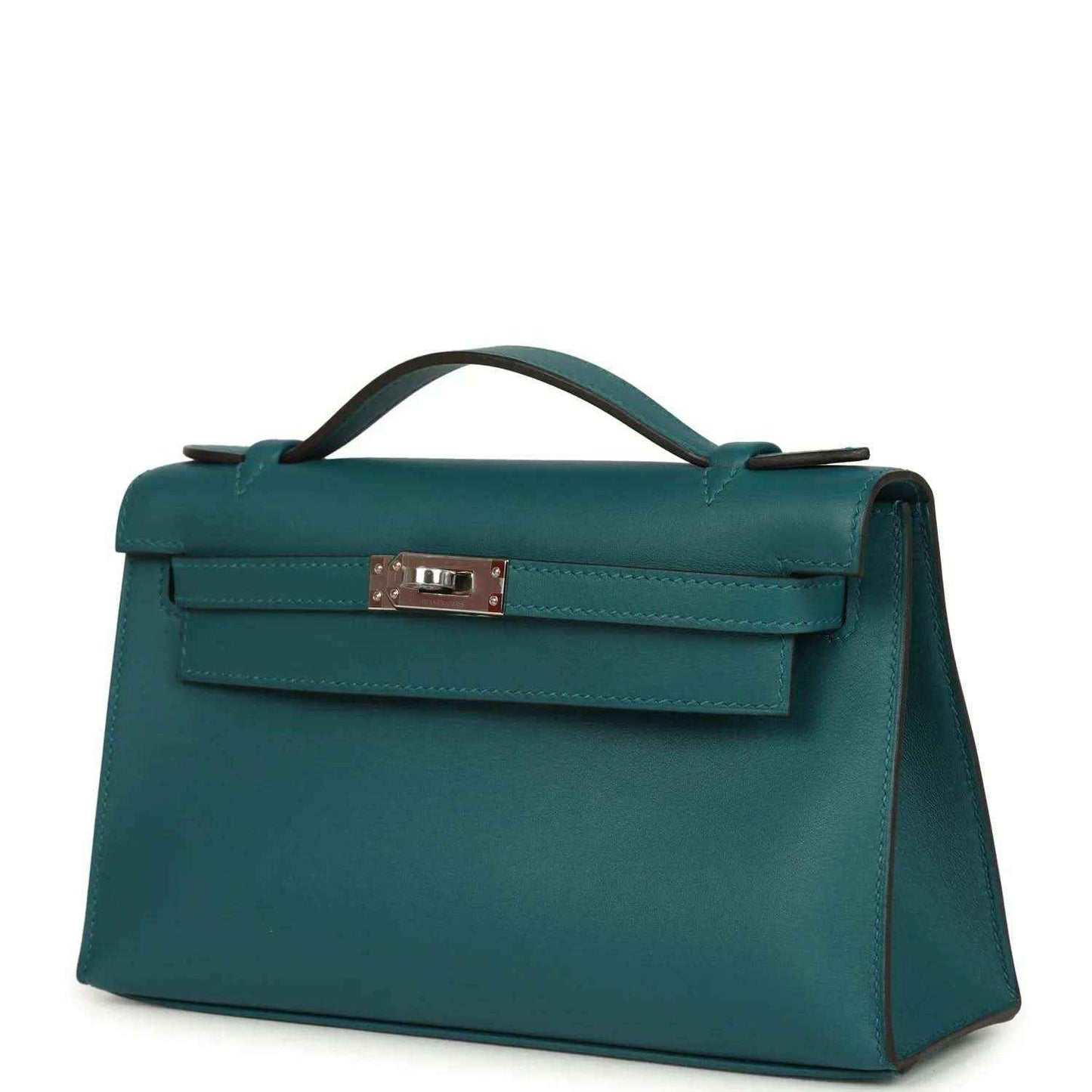 Teal green leather handbag with front flap and silver-toned clasp, three-quarter view.