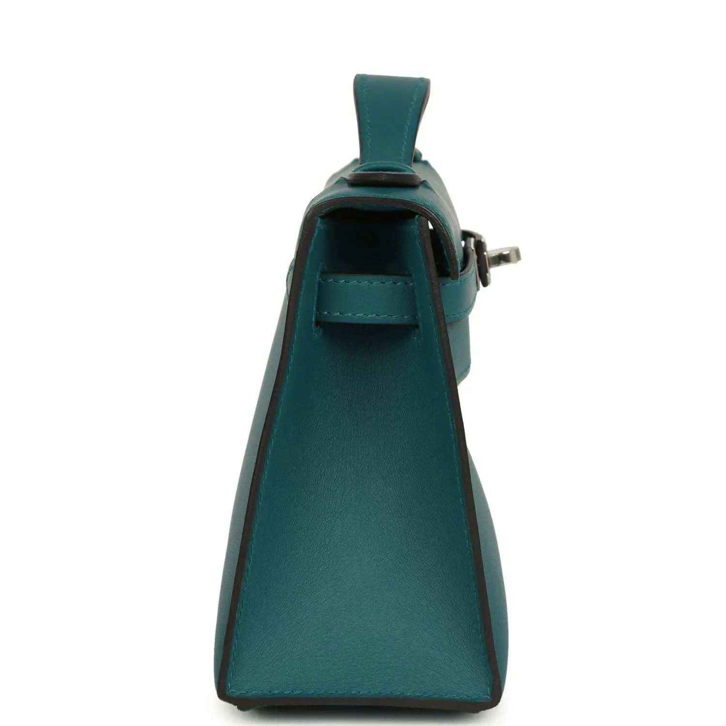 Teal green leather flap bag with side strap and silver-toned clasp hardware.