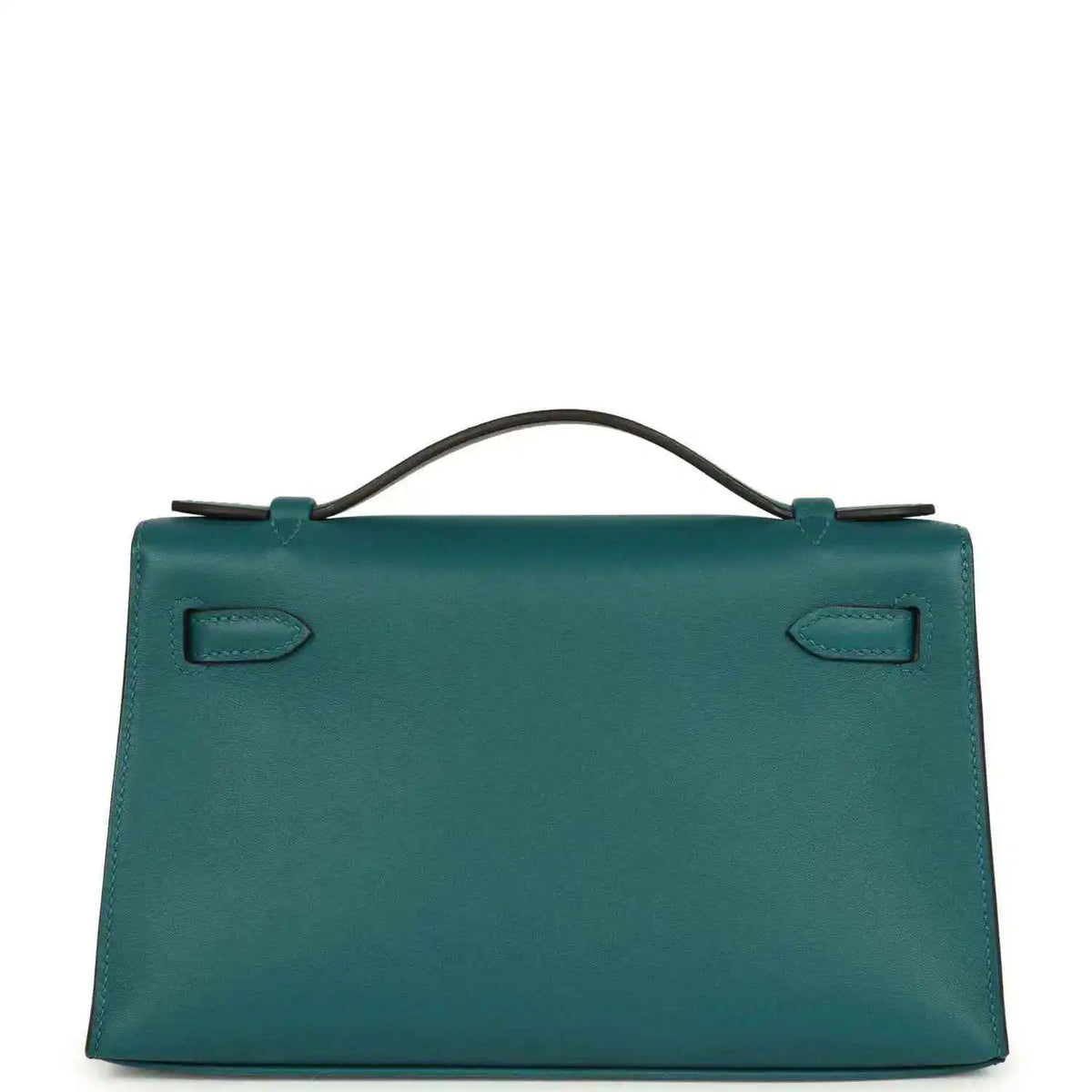 Teal green leather handbag with top handle and stitched corner tabs, back view.