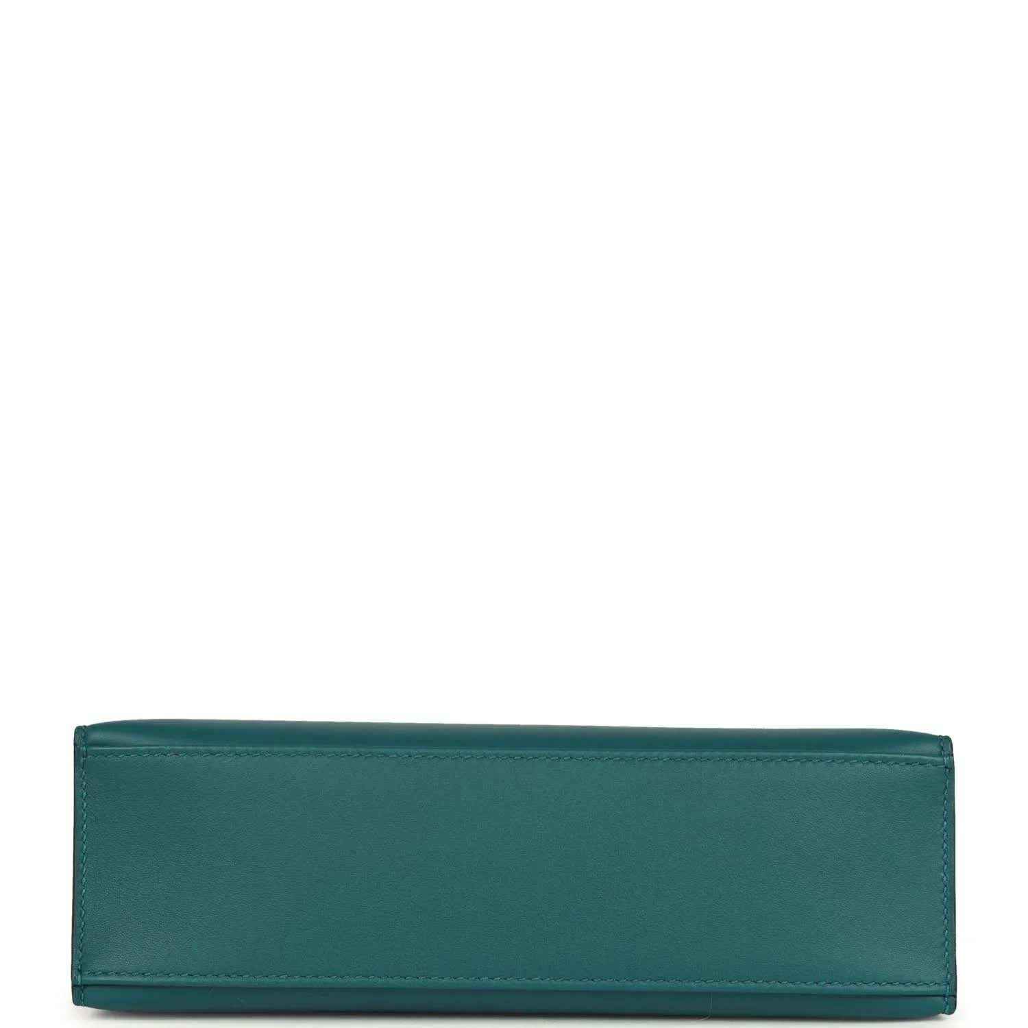 Teal green leather bag panel with stitched edges, close-up.