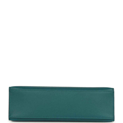 Teal green leather bag panel with stitched edges, close-up.