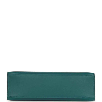 Teal green leather bag panel with stitched edges, close-up.