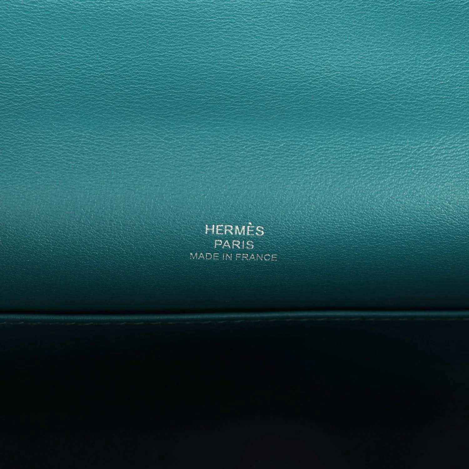 Teal green leather stamp panel reading HERMÈS PARIS MADE IN FRANCE.