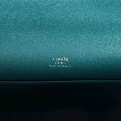 Teal green leather stamp panel reading HERMÈS PARIS MADE IN FRANCE.