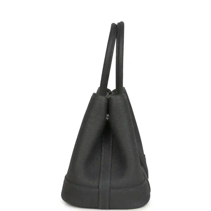 Dark gray leather tote bag viewed from the side with double top handles