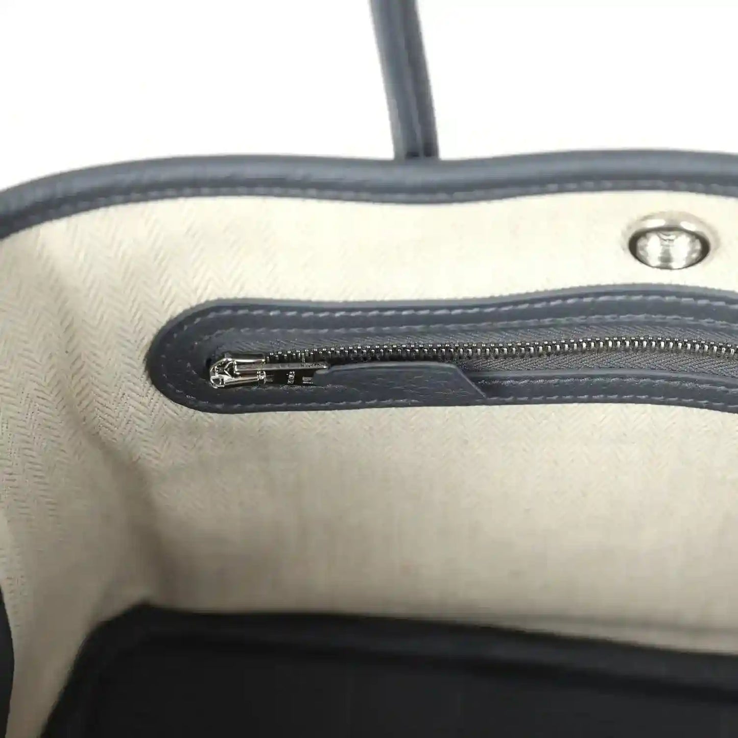Cream interior lining with dark zip track and metal zipper pull