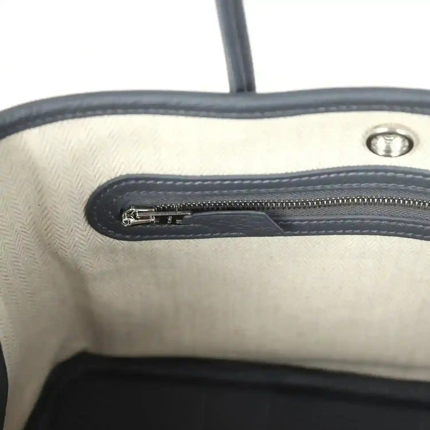 Cream interior lining with dark zip track and metal zipper pull
