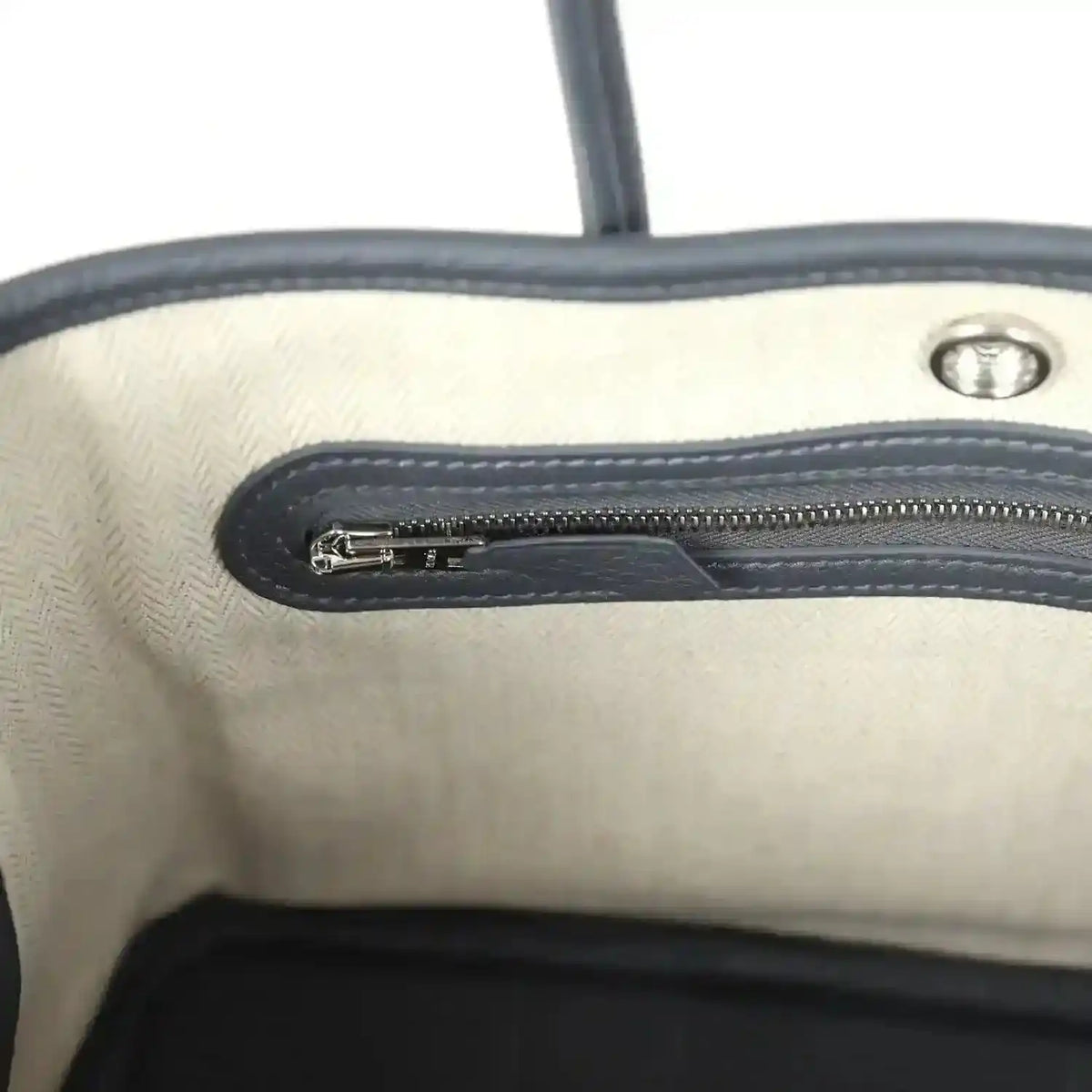 Cream interior lining with dark zip track and metal zipper pull