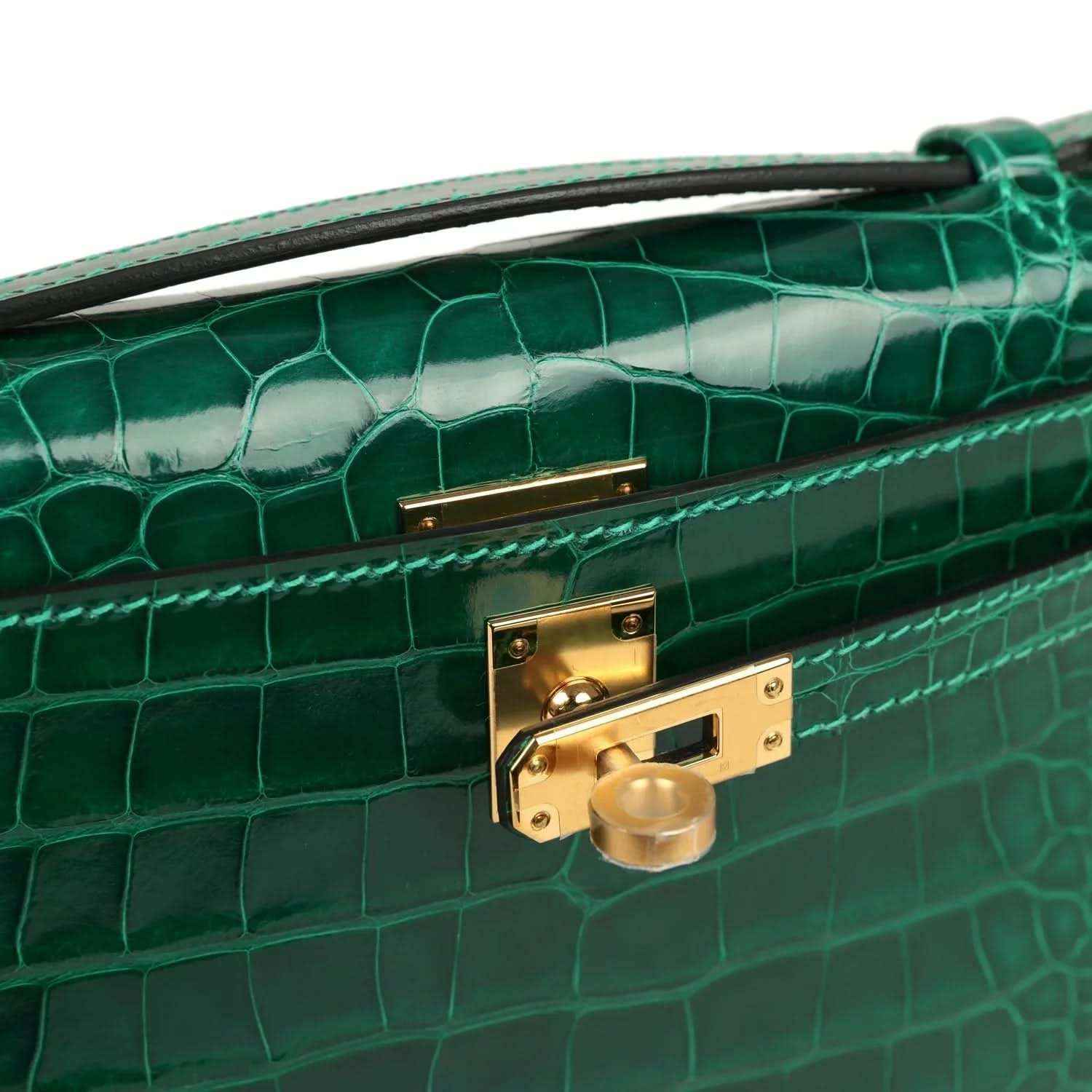 Hermes Kelly pochette bag close-up of gold front clasp on green alligator leather