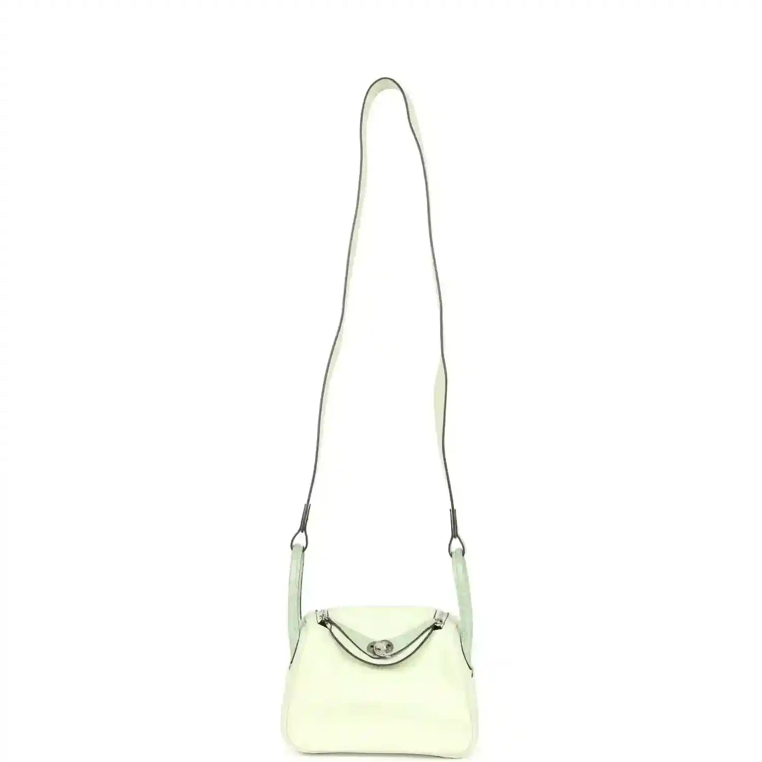 Mini Lindy mini bag on long strap, pale green leather with curved front clasp
