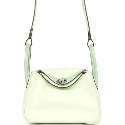 Mini Lindy crossbody bag in pale green and light cream leather, curved front flap