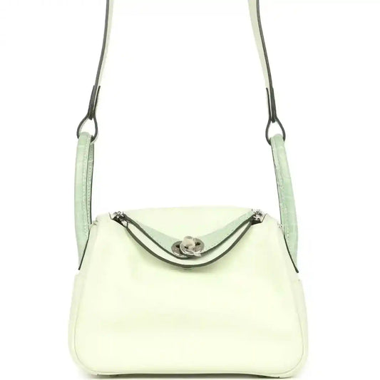 Mini Lindy crossbody bag in pale green and light cream leather, curved front flap