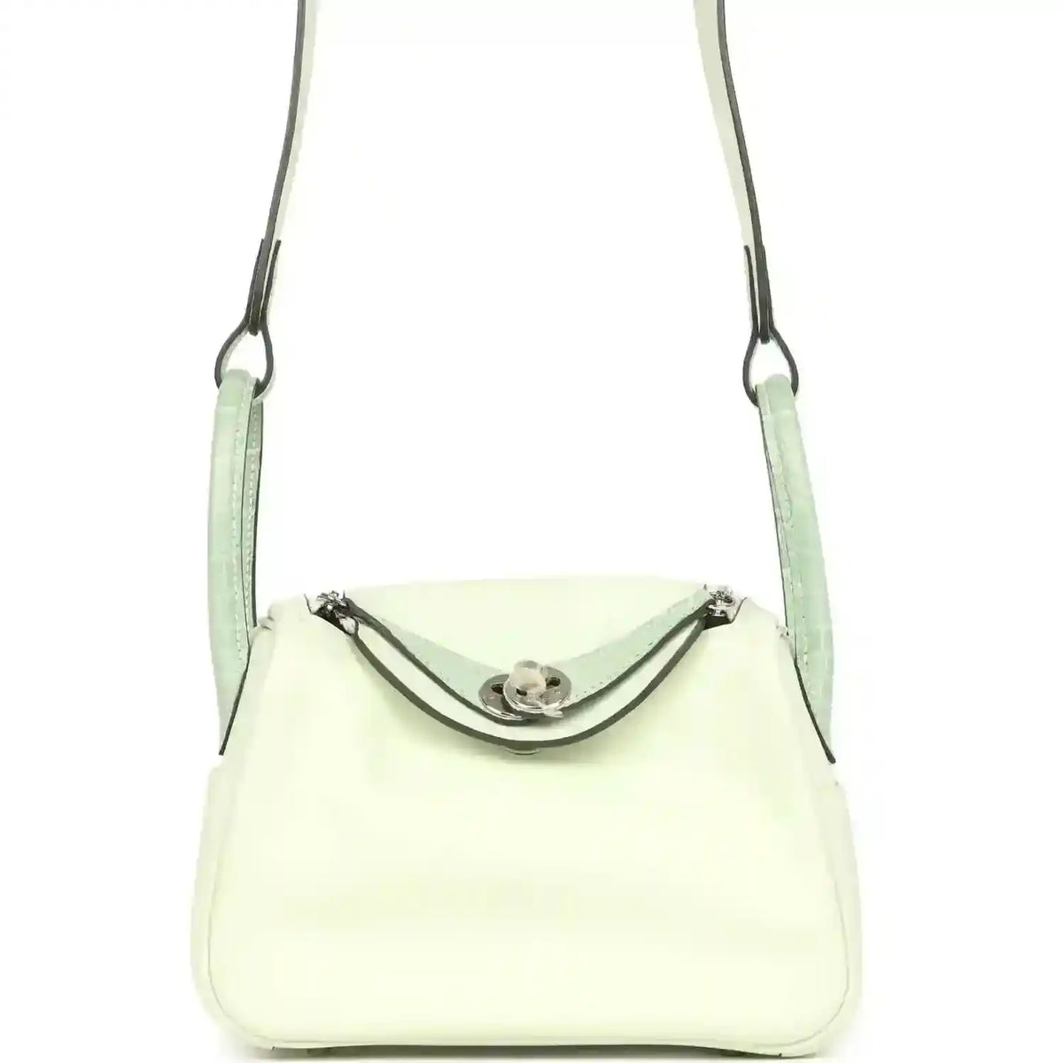 Mini Lindy crossbody bag in pale green and light cream leather, curved front flap