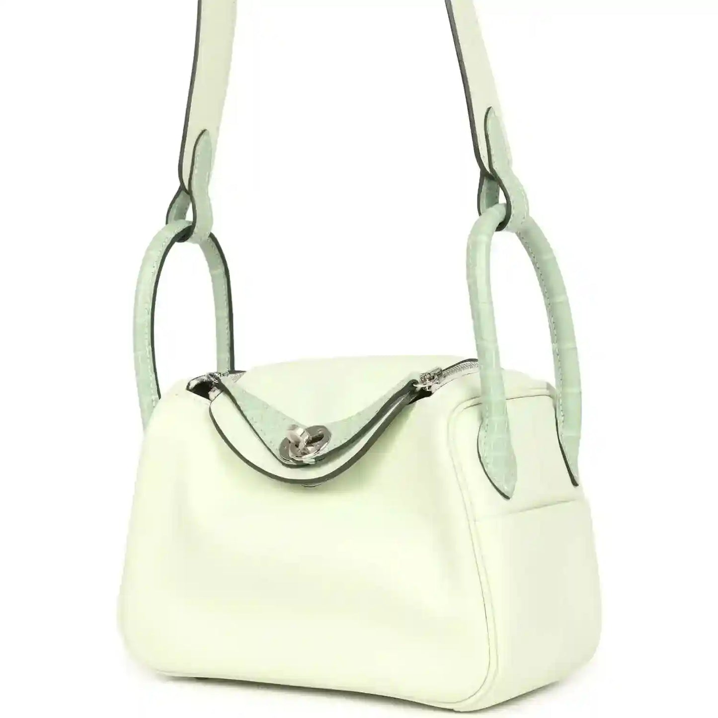 Mini Lindy bag front view in pale green leather, curved clasp and short handles