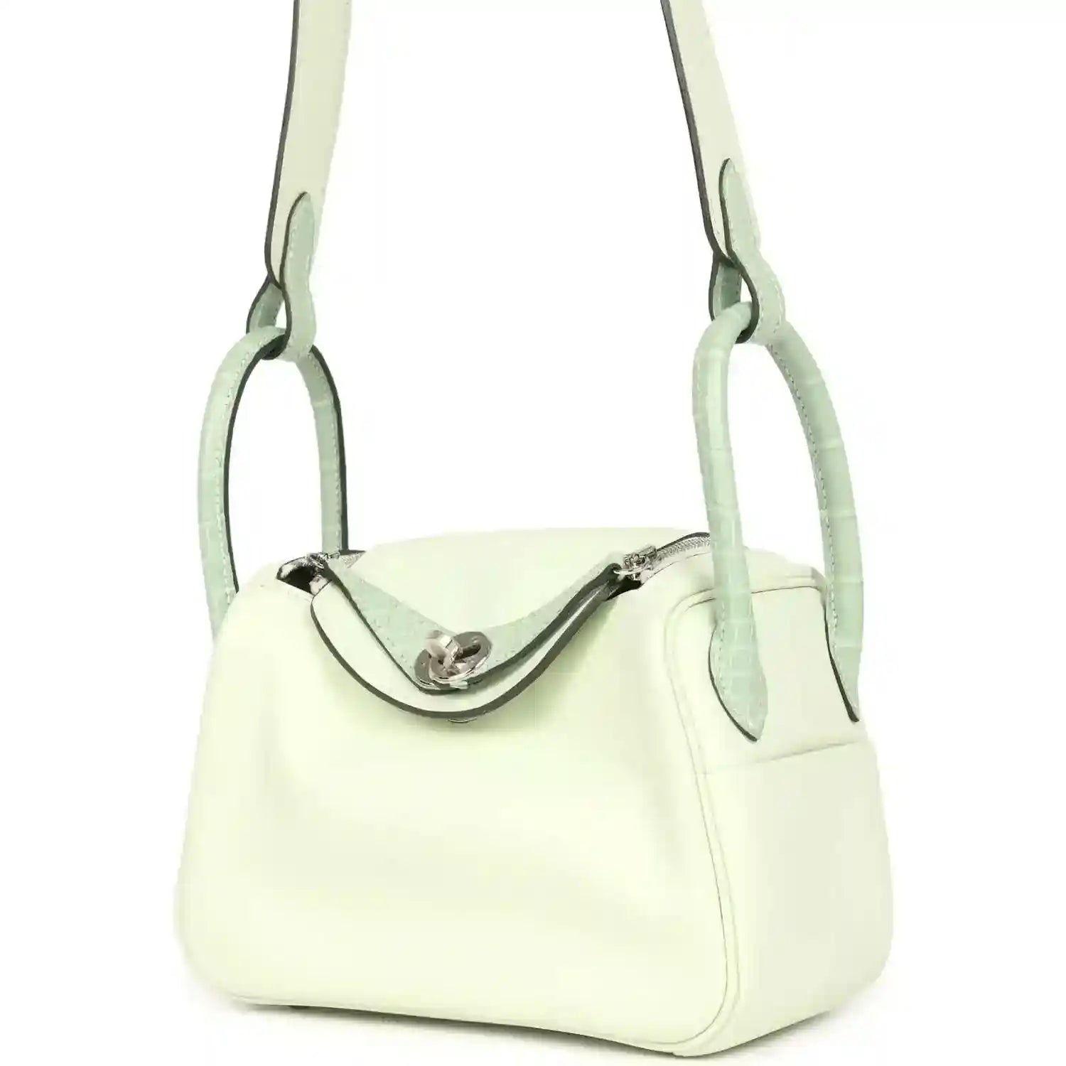 Mini Lindy bag front view in pale green leather, curved clasp and short handles