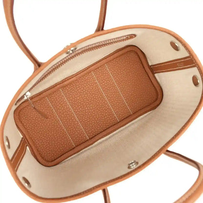Hermes Garden Party Neo 23 tote bag interior view, tan lining and zip pocket detail