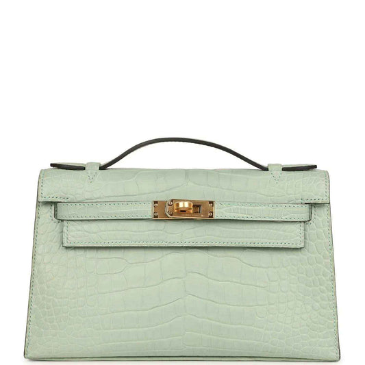 Mint green alligator-style pochette with top handle and gold front clasp