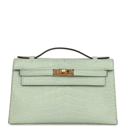 Mint green alligator-style pochette with top handle and gold front clasp