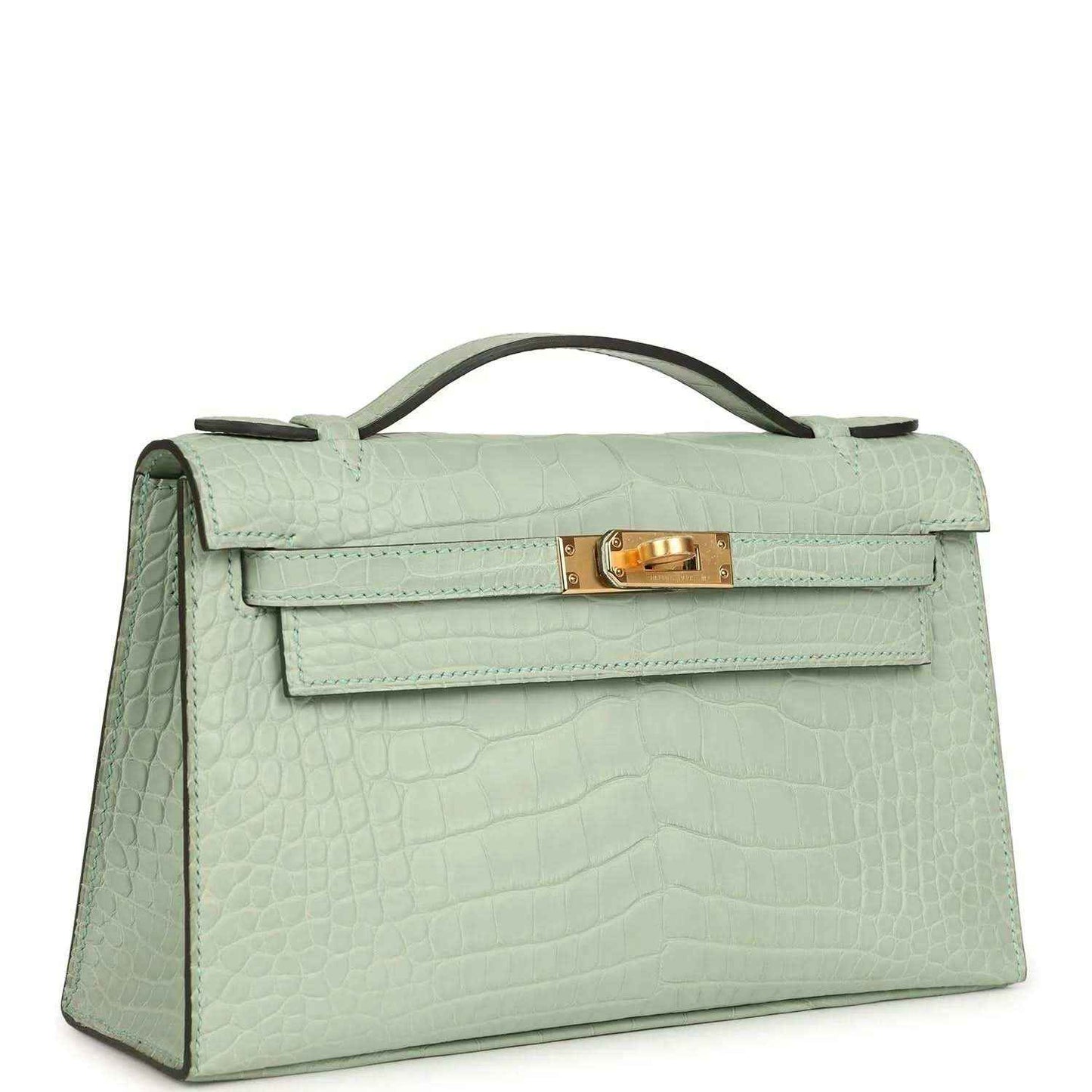 Mint green alligator-style pochette with flap, top handle, and gold clasp—angled view