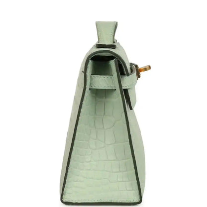 Mint green alligator-style pochette interior with open top and green lining