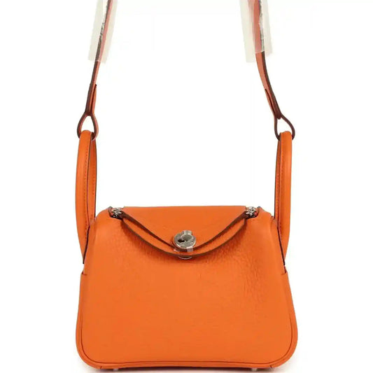 Orange clemence leather mini shoulder bag with flap closure and palladium-tone hardware.