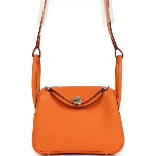 Orange clemence leather mini shoulder bag with flap closure and palladium-tone hardware.