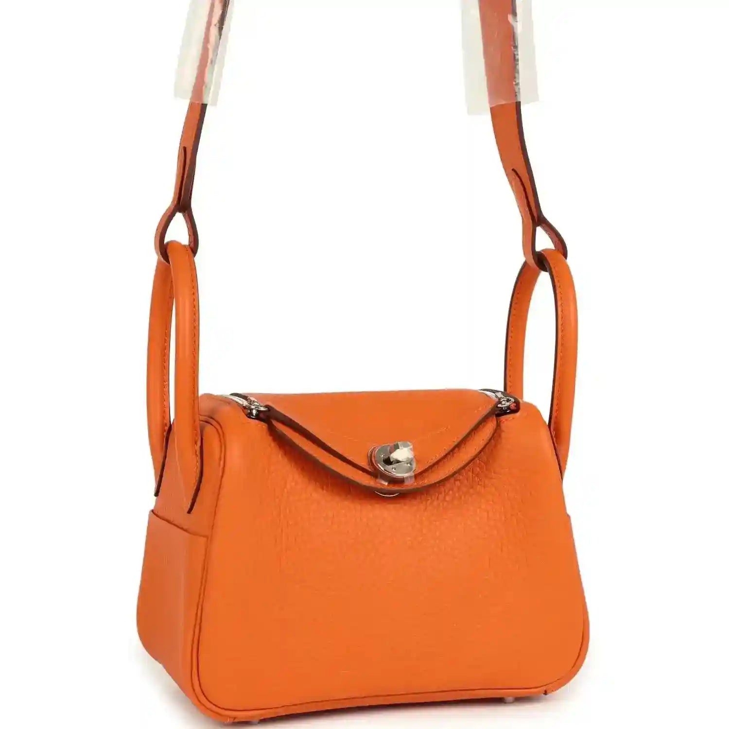 Orange mini handbag with crossbody strap, crescent flap, and palladium-tone clasp hardware.