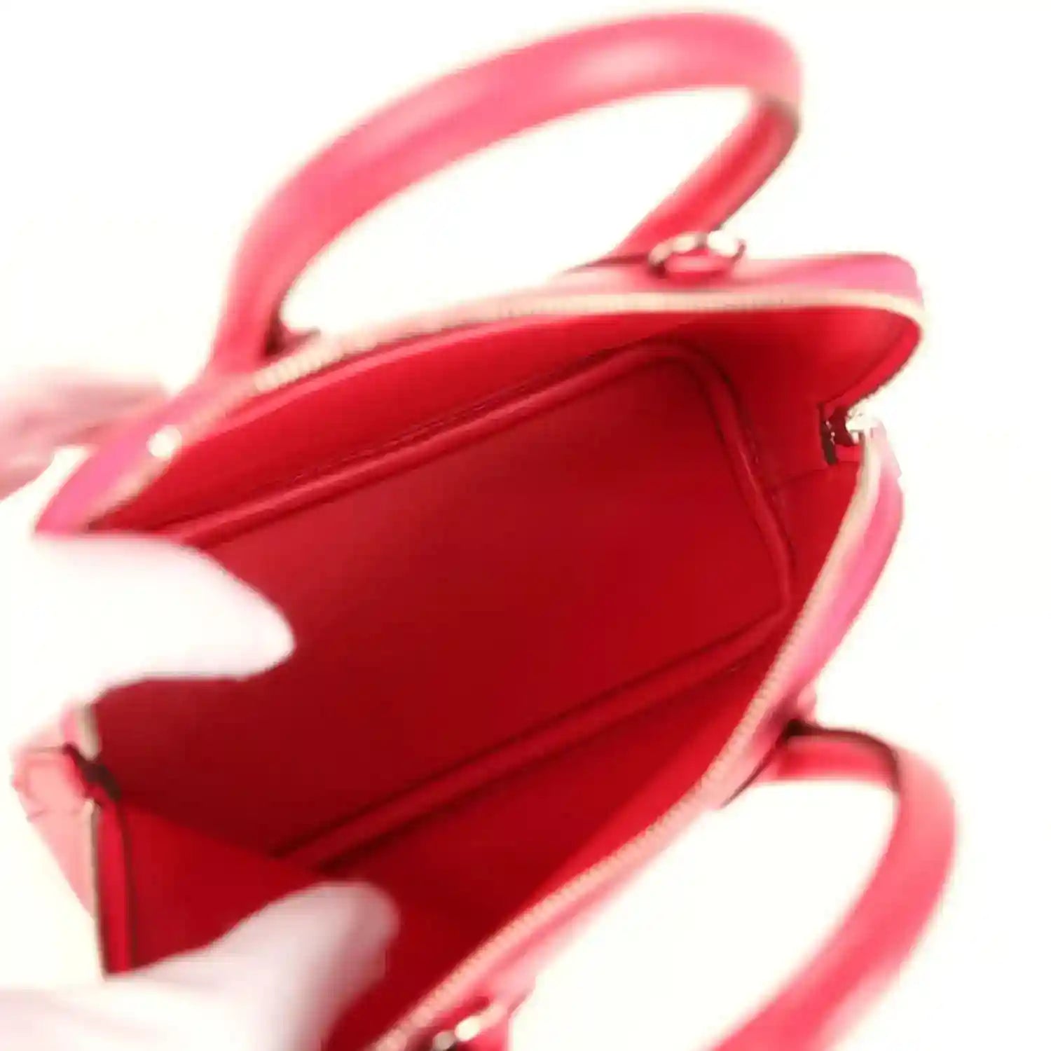 Hermes mini Bolide bag open top view showing red interior and top handle strap