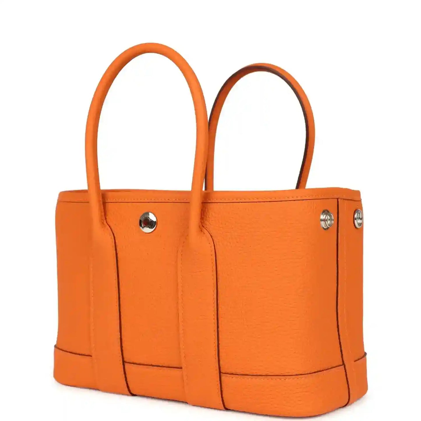 Orange leather tote bag with two handles and silver-toned side studs