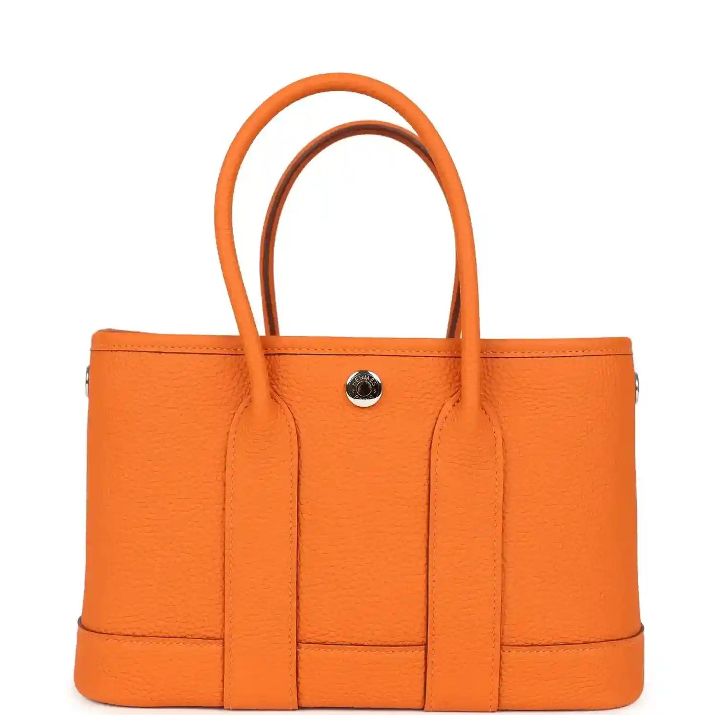 Orange leather tote bag with curved handles and round snap hardware