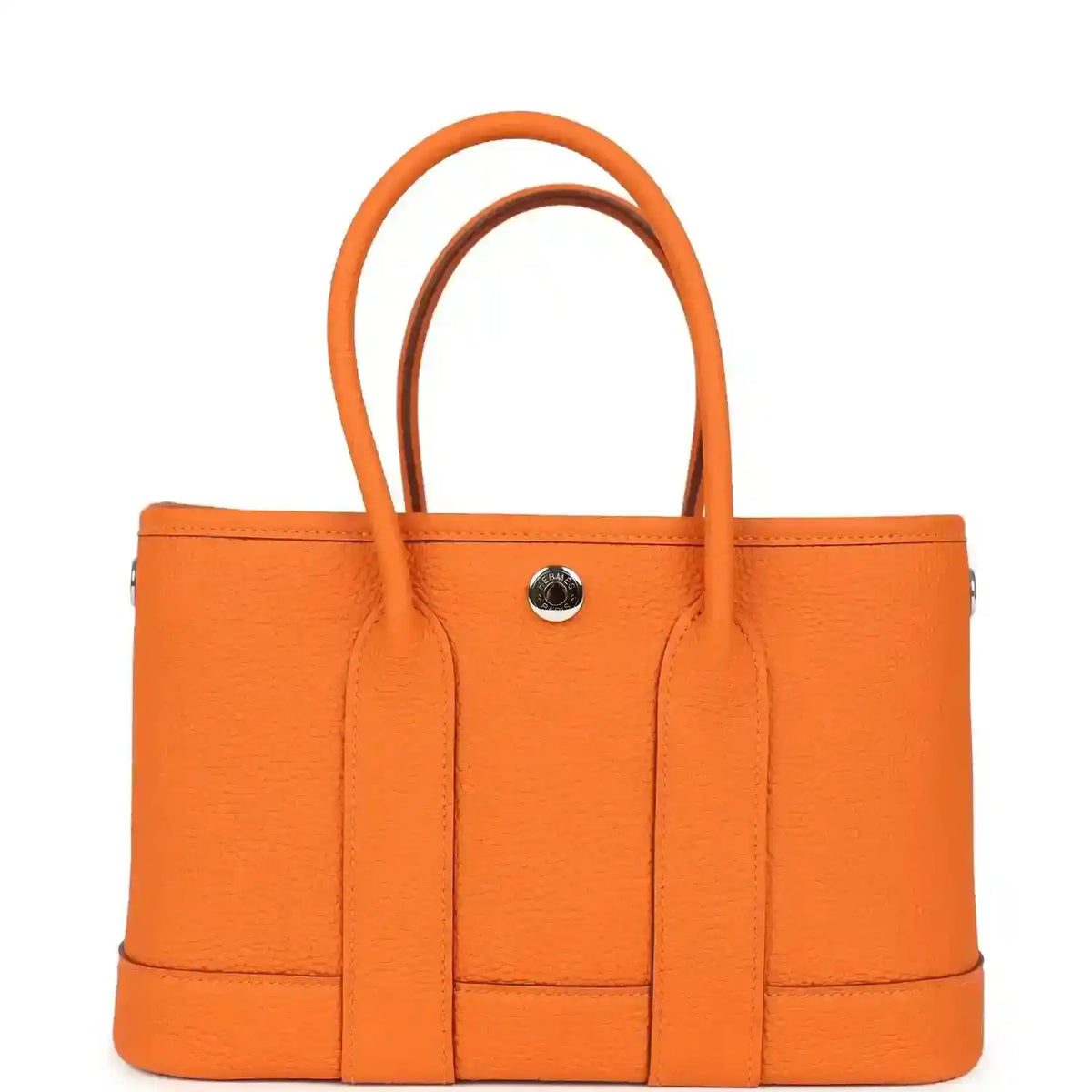 Orange leather tote bag with curved handles and round snap hardware