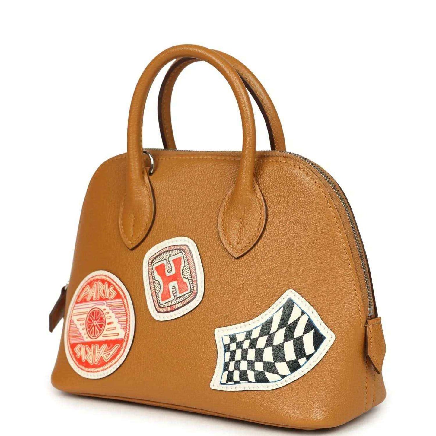Mini tan leather handbag with top handles, checkered patch, and logo emblems