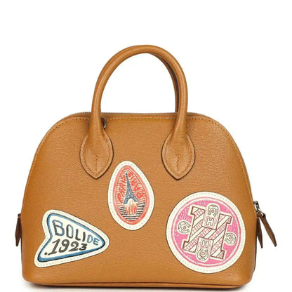 Mini tan leather handbag with two handles and mixed colorful logo patches