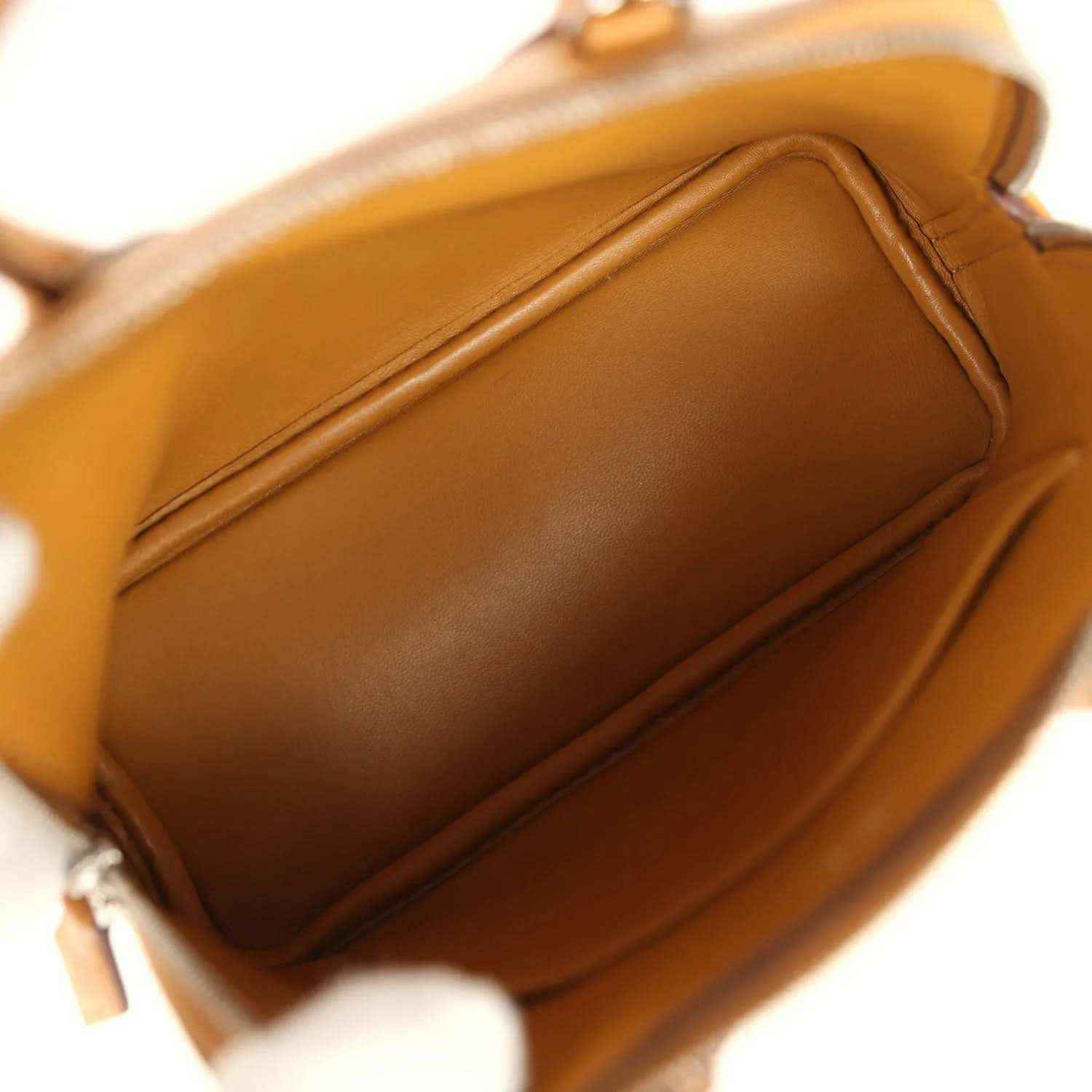 Mini tan handbag interior lining with stitched seam detail near the opening