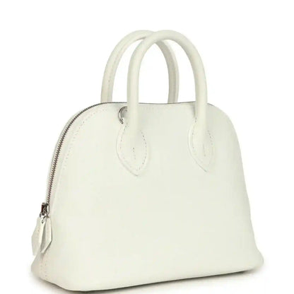 White leather Hermes mini Bolide bag with curved top handles and front zipper pocket
