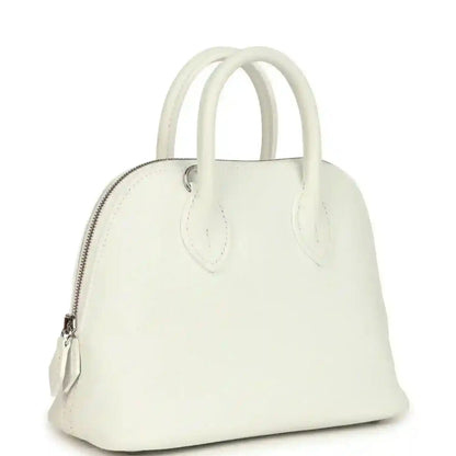 White leather Hermes mini Bolide bag with curved top handles and front zipper pocket