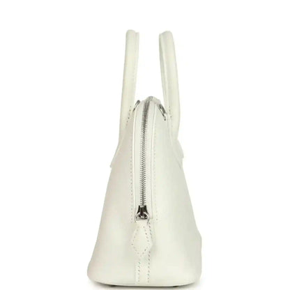 White Hermes mini Bolide bag showing side profile and front zipper pull